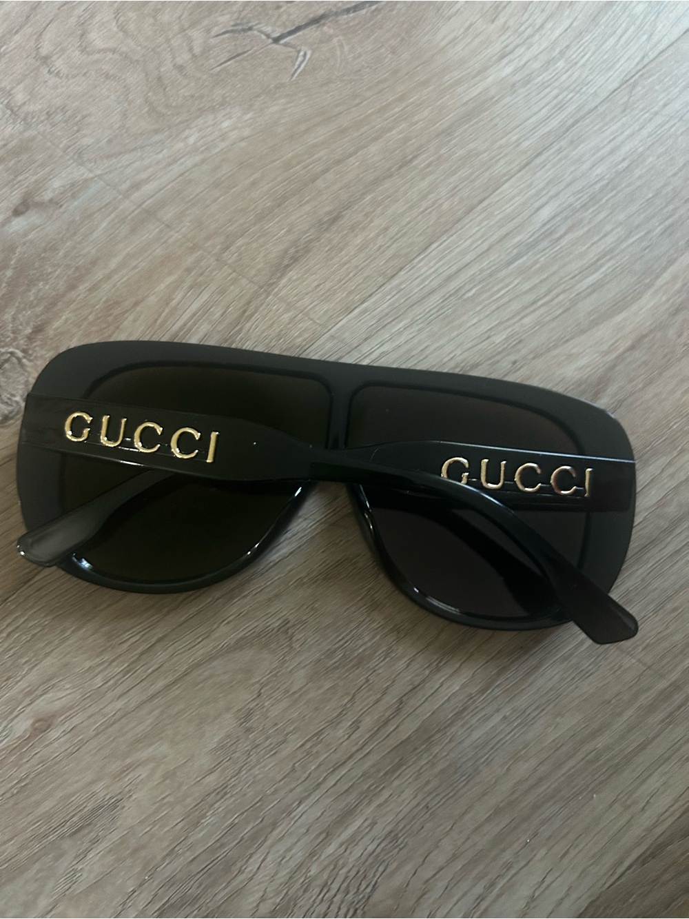 Black Sunglasses with Gold Logo Accents